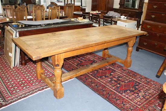 A large 17th century style pine refectory table, on turned legs with H stretcher, W.243cm D.92cm H.75cm